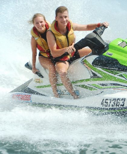 Couple having fun on jet ski in water